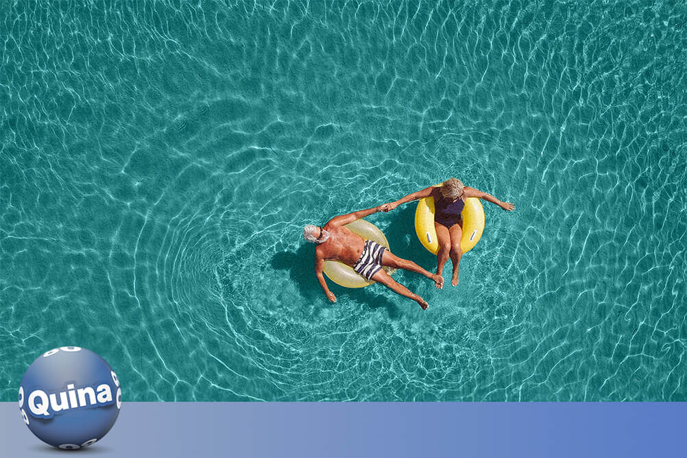 Um casal aproveitando uma piscina depois de descobrir as estatísticas e melhorar suas chances com os números da Quina.
